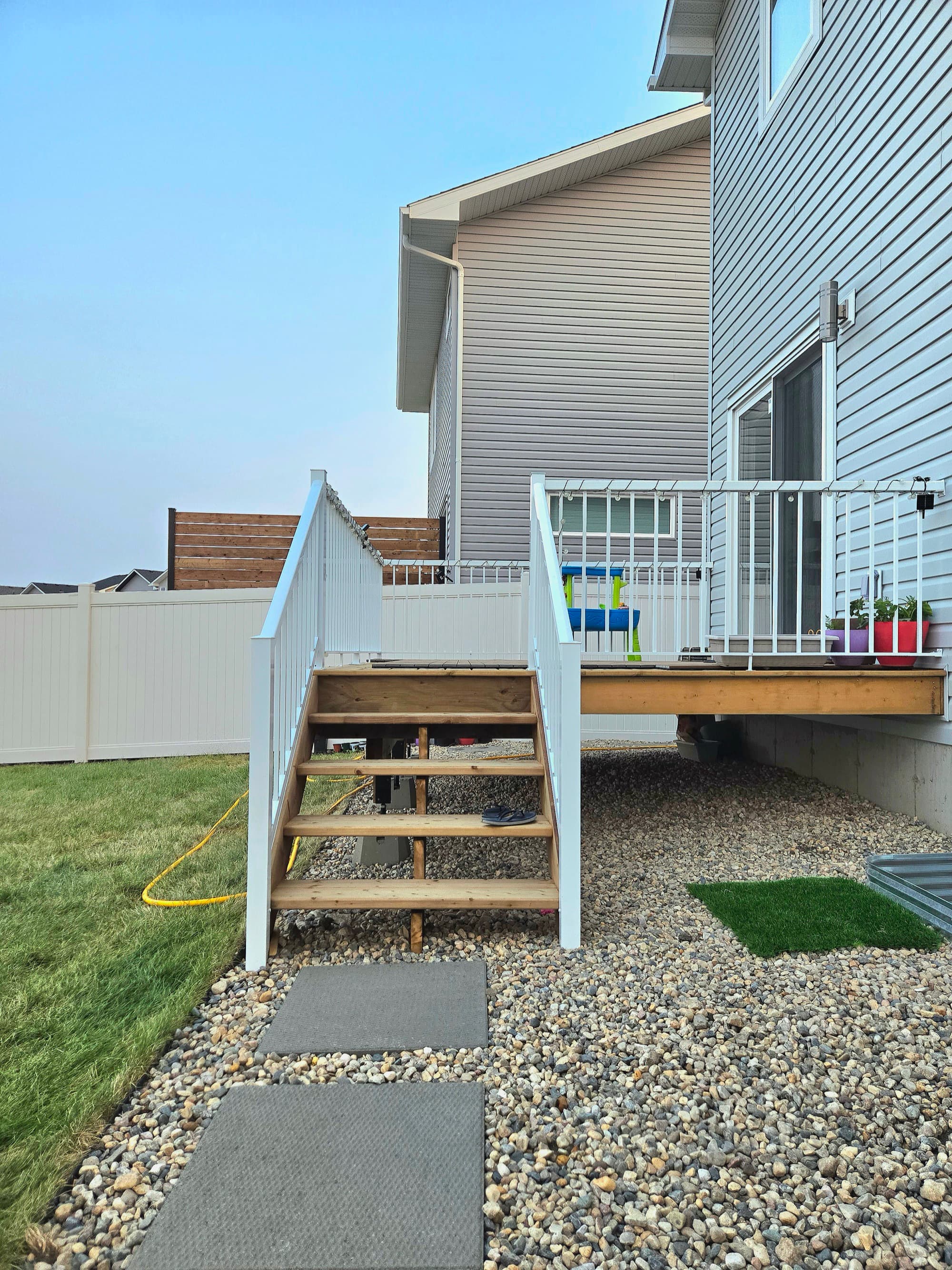 Composite deck with white railing — Stonebridge, Saskatoon